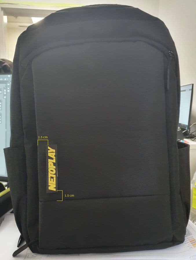 Example of a yellow logo placement on a black backpack